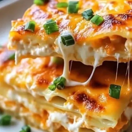 Buffalo Chicken Lasagna with Ranch topped with cheese and green onions