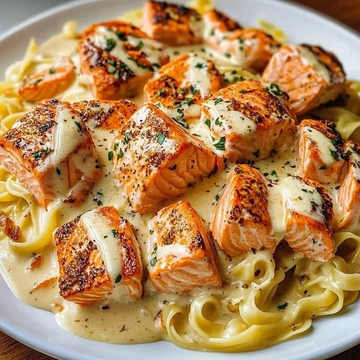 Delicious Cajun Lobster Salmon Alfredo served with a creamy sauce.