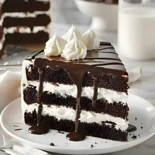 Decadent chocolate cake topped with rich chocolate frosting and sprinkles.