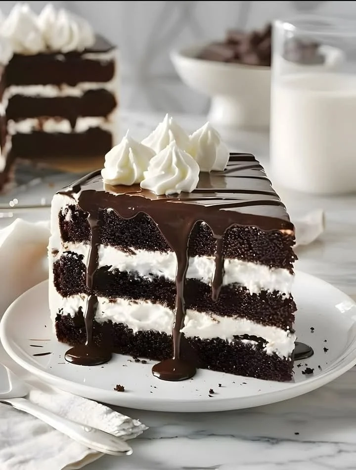 Decadent chocolate cake topped with rich chocolate frosting and sprinkles.