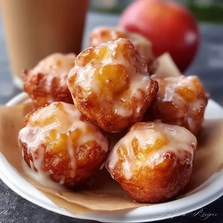 Delicious cinnamon-glazed apple fritter with chunks of apples and a sweet glaze