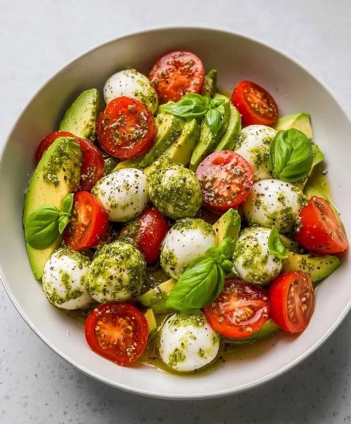 Creamy avocado caprese salad with fresh tomatoes and mozzarella