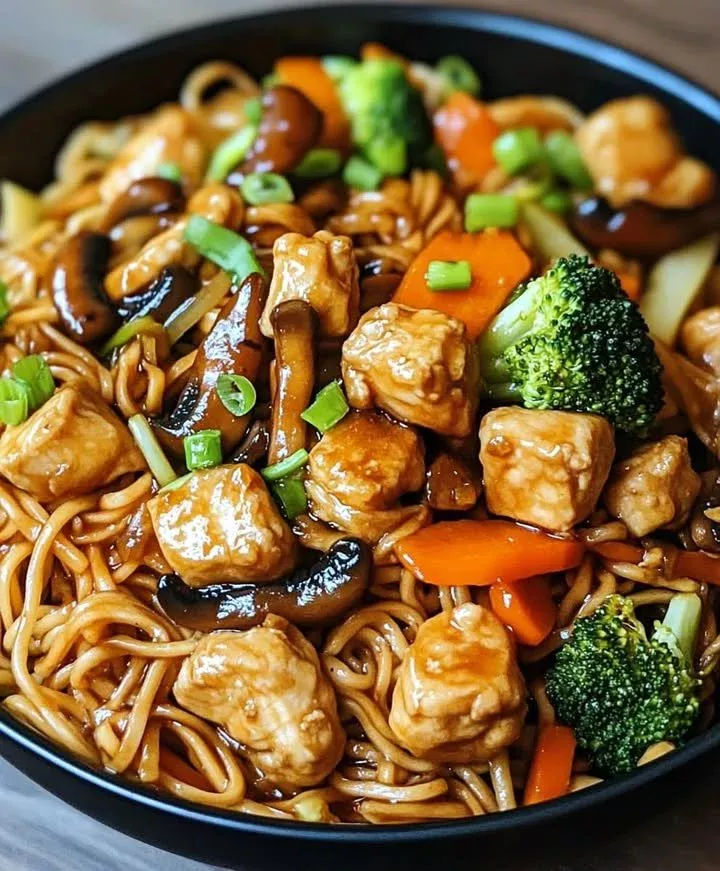 Dish of Garlic Chicken Lo Mein with fresh vegetables and savory sauce