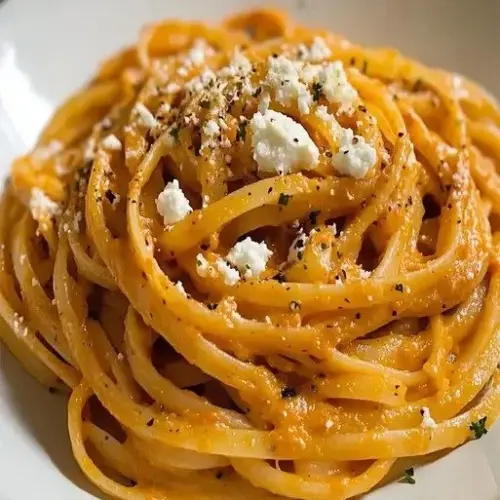 Delicious goat cheese linguine topped with grilled peppers served in a bowl