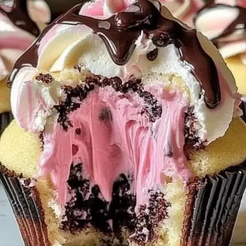 Delicious Neapolitan Cream Cupcakes showcasing chocolate, vanilla, and strawberry layers.