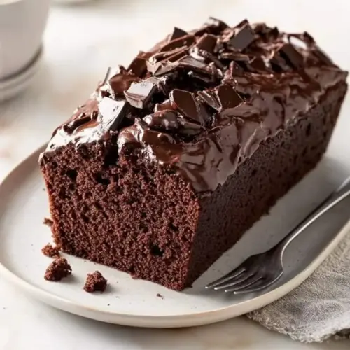 Delicious quick chocolate loaf cake topped with chocolate frosting