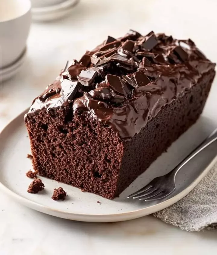 Delicious quick chocolate loaf cake topped with chocolate frosting