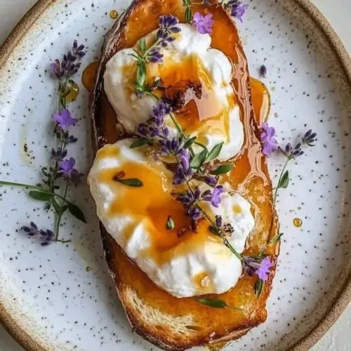 Delicious ricotta croissants drizzled with burnt honey on a plate.