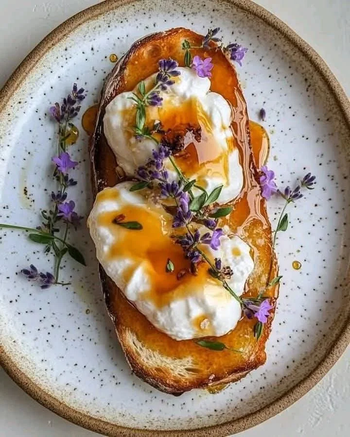 Delicious ricotta croissants drizzled with burnt honey on a plate.