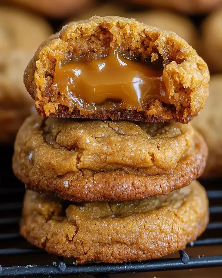 Freshly baked super creamy caramel cookies on a cooling rack